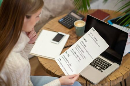 Working on a menu. A cafe owner creating a menu for her restaurant