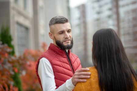 Tender moments. Handsome young man touching his girlfriends shoulder while telling her about his feelingsの写真素材