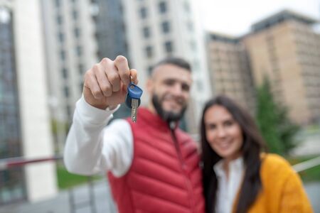 New apartment. Selective focus of a keys from a new house of a nice young couple