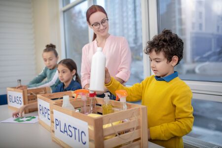 Learning important things. Children learning sorting waste and recycling at schoolの写真素材
