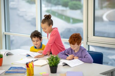 Buddy group. Three kids helping each other with the home task