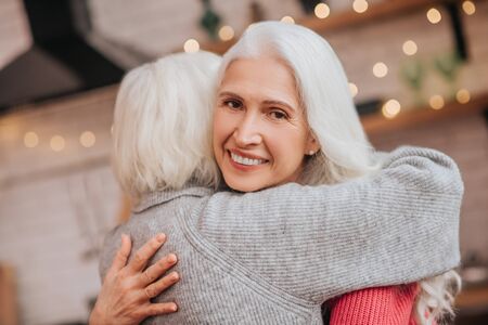 Happy people. Two mature grey-haired positive ladies looking happyの写真素材