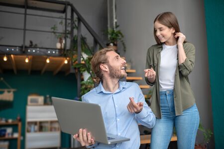Planning a new project. A smiling man and woman discussing work tasks together