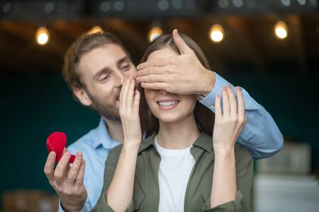 Thrilling moment. A man presenting engagement ring to the womanの写真素材