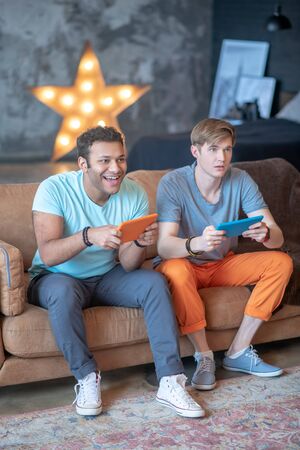 Videogames. Two friends playing videogames and feeling great