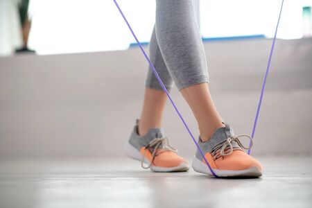 At rehabilitation center. Female patient legs walking with jump rope