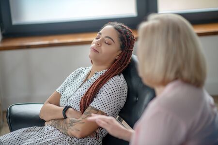 Depression. Young woman having a therapy session and feeling frustratedの写真素材