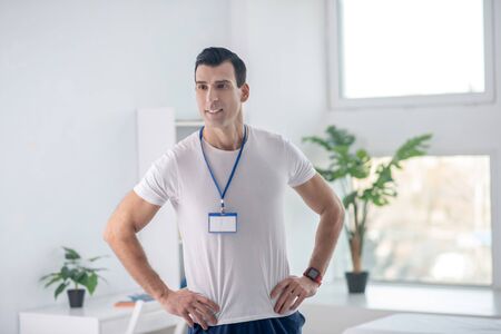 Professional coach. Handsome muscular man thinking about his work while working as a coach in the...