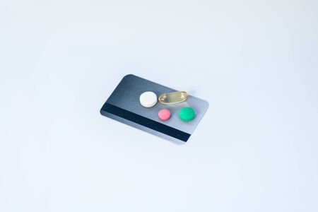 Need pills. Colorful pills laying on a credit card