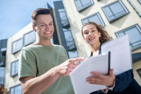 Elegant businesswoman showing the agreement to her clientの写真素材