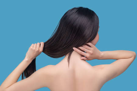Healthy hair. A young woman having long dark healthy hairの写真素材