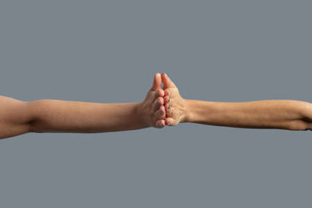 Brotherhood of mankind. Close-up of people from different races holding palms togetherの写真素材
