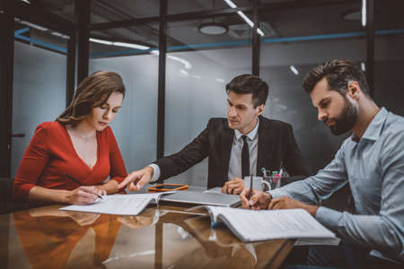 Legal consultation. A professional lawyer consulting spouses about legal documents