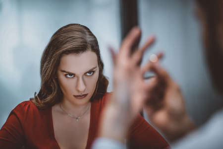 Unpleasant moment. A woman looking at how her husband taking off the wedding ringの写真素材