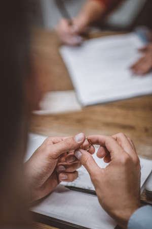 Divorced. A woman holding his wedding ring after getting divorcedの写真素材
