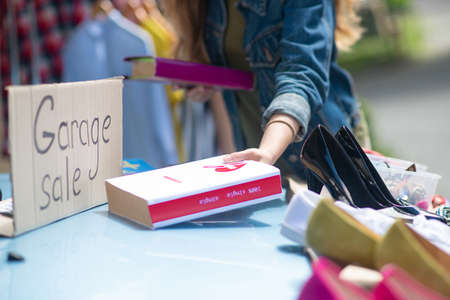 Interesting novel. Close up of a book being taken by a nice young woman