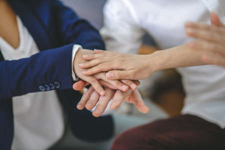 Collaboration, cohesion. Hands of young people showing gesture of their cohesion, support and unity,...