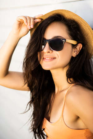 Model. Pretty brunette girl in a straw hat posing for the cameraの写真素材