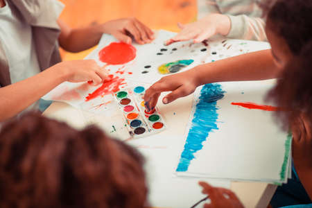 Art skills. Kids draawing with fingers during the art classの写真素材