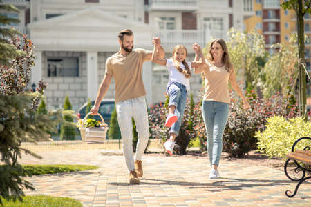 Summer time. Young cute family walking and looking energizedの写真素材