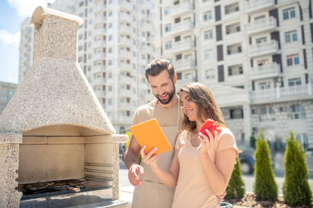 Funny video. Young couple watching something on internet and smilingの写真素材