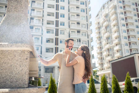 Happy couple. Beautiful couple standing in the yard and looking happyの写真素材