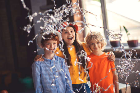 Three cute kids enjoying a birthday party