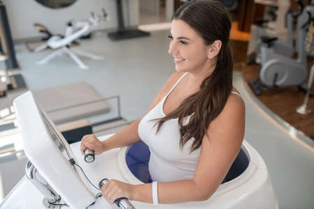 Double effect. A woman running in a new spa treadmill