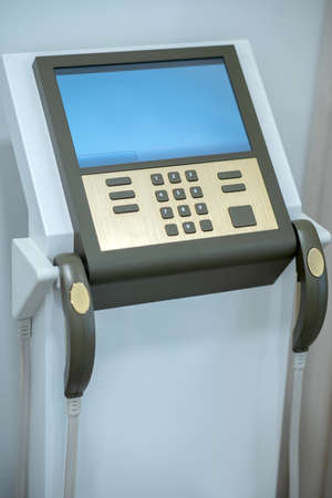 Diagnostic apparatus. Monitor and control buttons of a diagnostic device standing in room in medical...