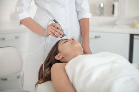 Beauty treatment. Cosmetologist working with a female customer in a beauty salonの写真素材
