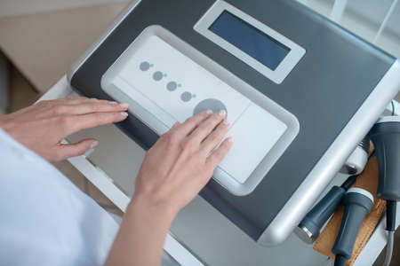 Medical equipment. Close up picture of medical equipment and human hands pressing the button