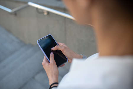 Smartphone. Woman holding a smartphone in her hands