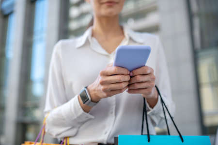 Smartphone. Close up picture of a woman with a smartphoneの写真素材