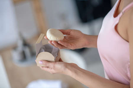 New type of cosmetics. A woman holding a new moisturising soap productの写真素材