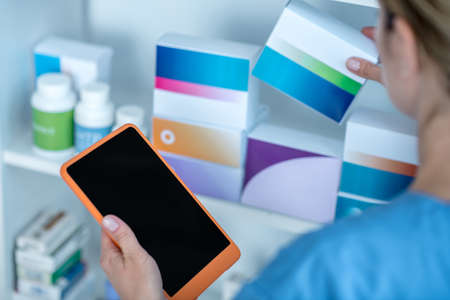 Medicine. Close up of a doctor taking package with pills