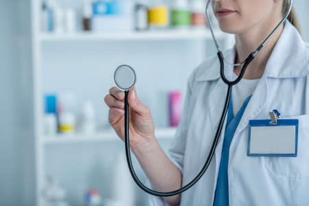 Ready for examining. Doctor in a lab coat holding a stethoscopeの写真素材