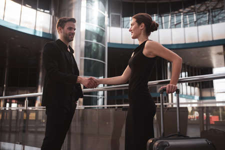 Women in business. Male and female business partners shaking each others handsの写真素材