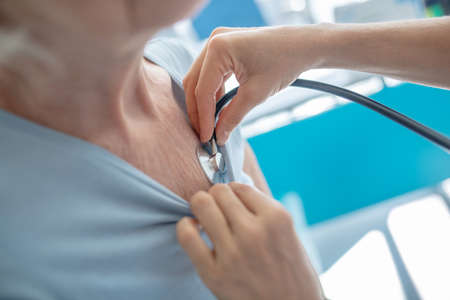 Examining a patient. Close up picture of doctors hand with stethoscopeの写真素材