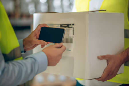 Code reader. Close up picture of mans hands making barcodesの写真素材