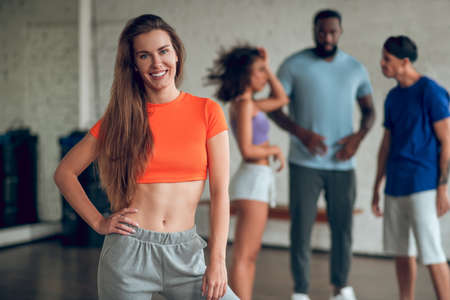 Dancing together. A smiling woman having a dance rehearsal with her colleagues