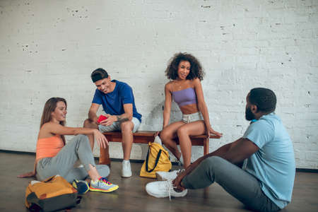 Working on mistakes. A group of dancers discussing their past rehearsal