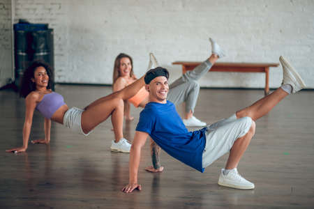 Teaching modern dance styles. A teacher shows break-dance movements to his students