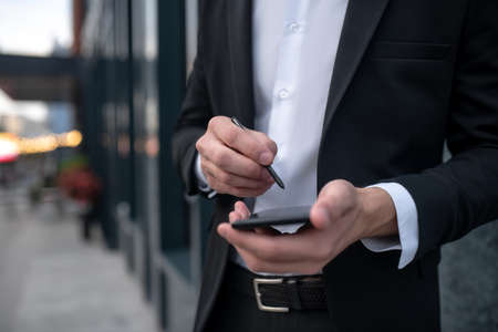 Smartphone. Close up of mans hands holding smartphoneの写真素材