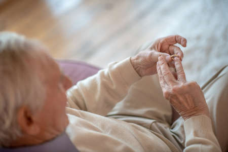 Wedding ring. Close up picture of elderly mans hand with a wedding ringの写真素材