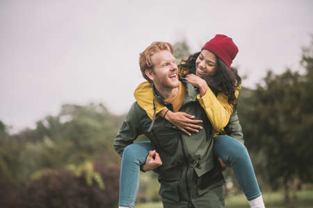 Like kids. Young happy couple enjoyingand having fun together
