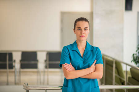 Determined. Pretty young female doctor in blue uniform looking determinedの写真素材