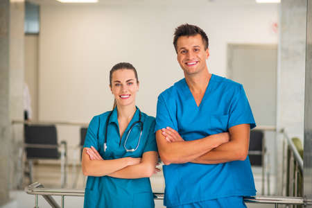 At work. Two doctors standing with arms crossed and smilingの写真素材