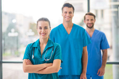 Doctors at work. Group of doctors standing and looking positiveの写真素材