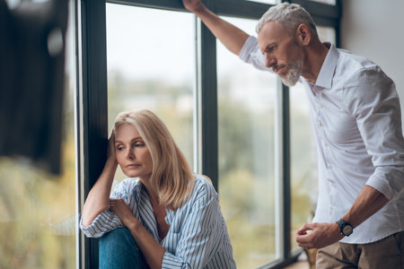 Crisis. Married couple having hard conversation and looking upsetの写真素材