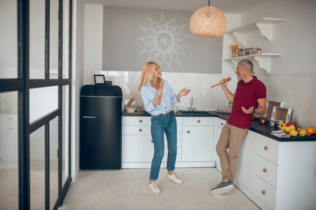 happy couple. Man and woman singing, enjoying and having funの写真素材